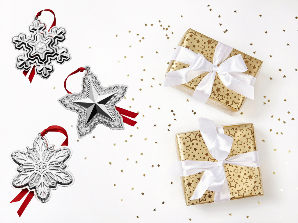 Silver Christmas ornaments alongside gold-wrapped gift boxes.